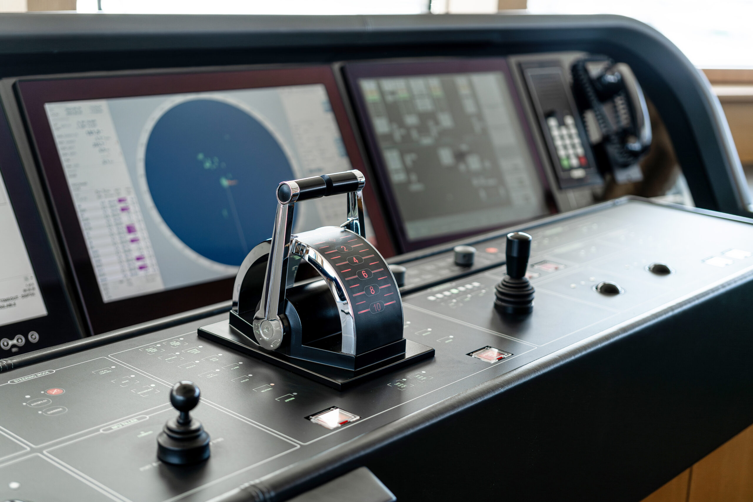 Modern yacht navigation screens and helm controls inside a refined yacht interior