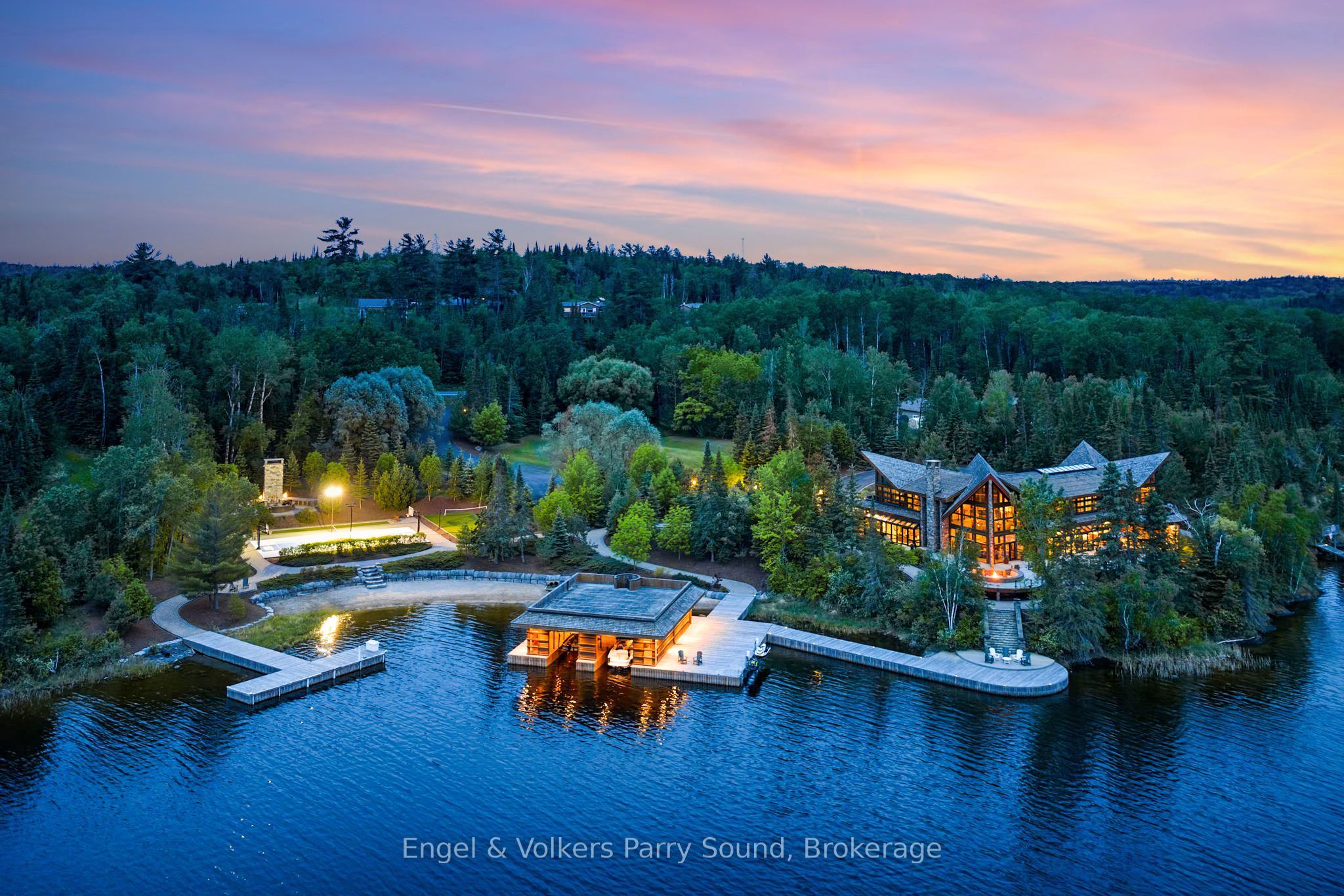 Waterfront estate with extensive private dockage at sunset in Kenora, Ontario